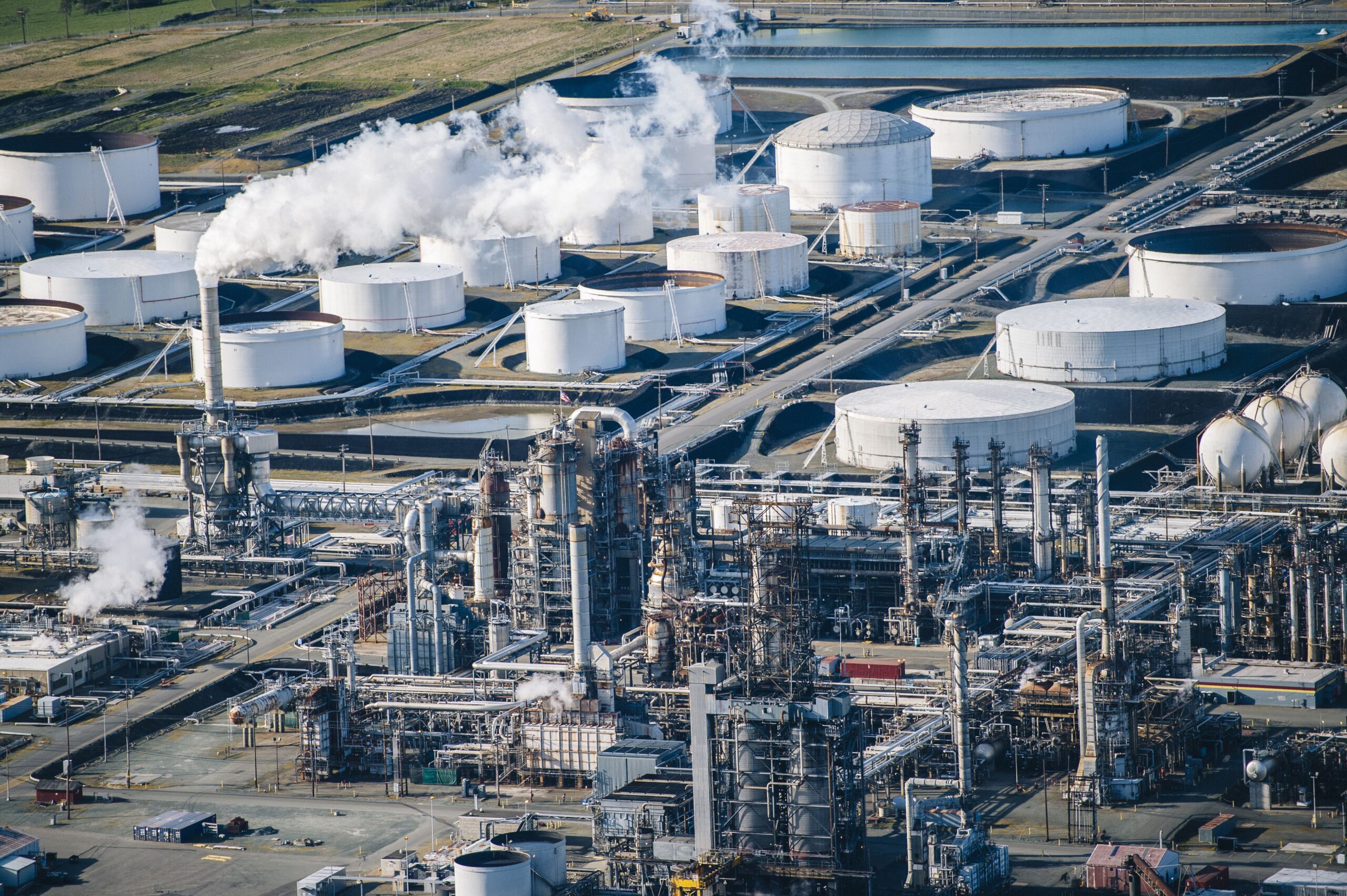 Rows Of White Oil Storage Tanks And Smoke Stack In 2026 01 09 10 24 13 Utc 1 Scaled